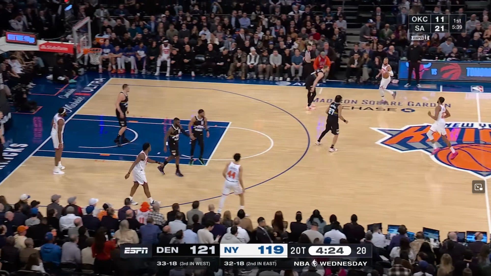 Basketball game with player holding ball highlighted